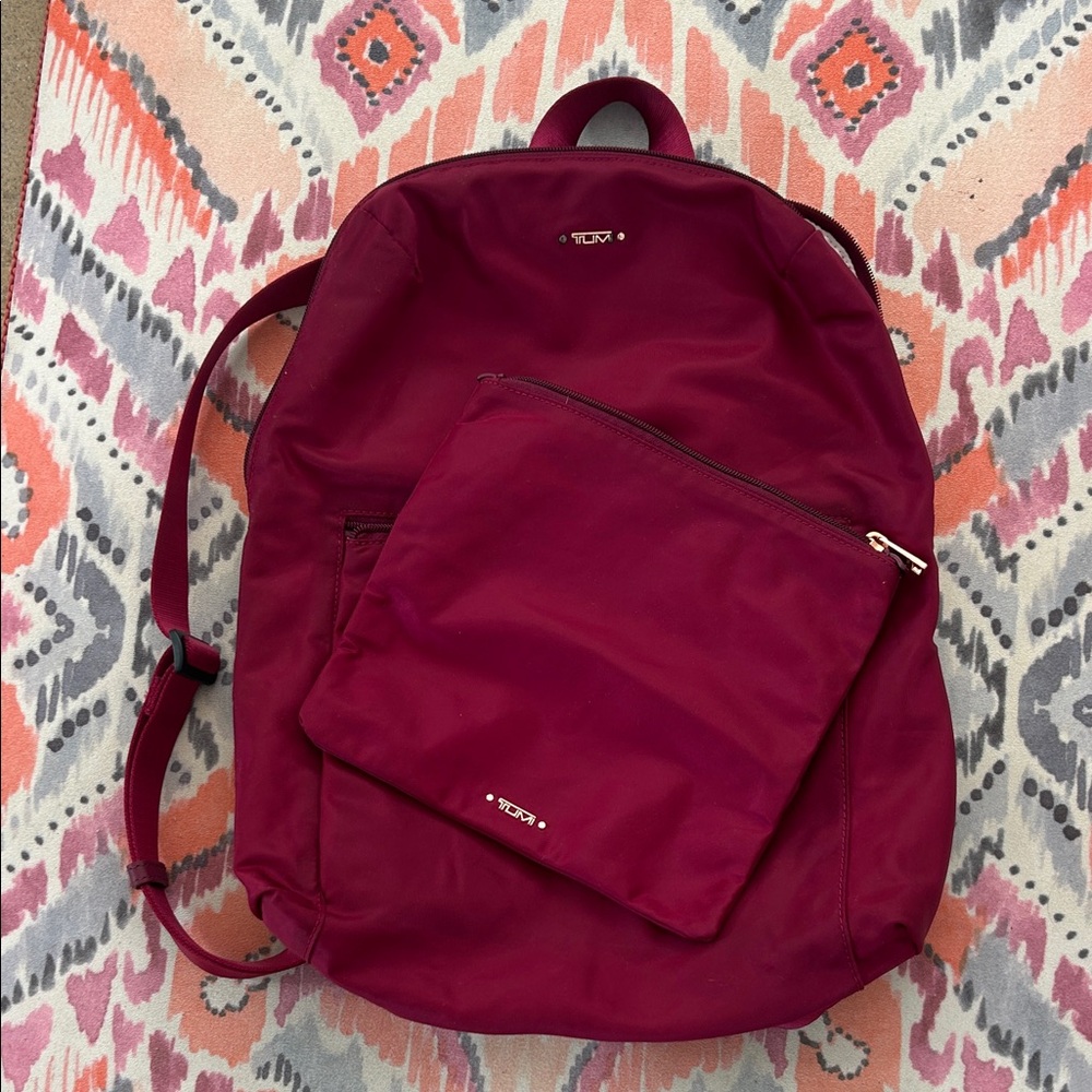 Tumi Nylon Voyager burgundy wine color
Backpack with rose gold accents.